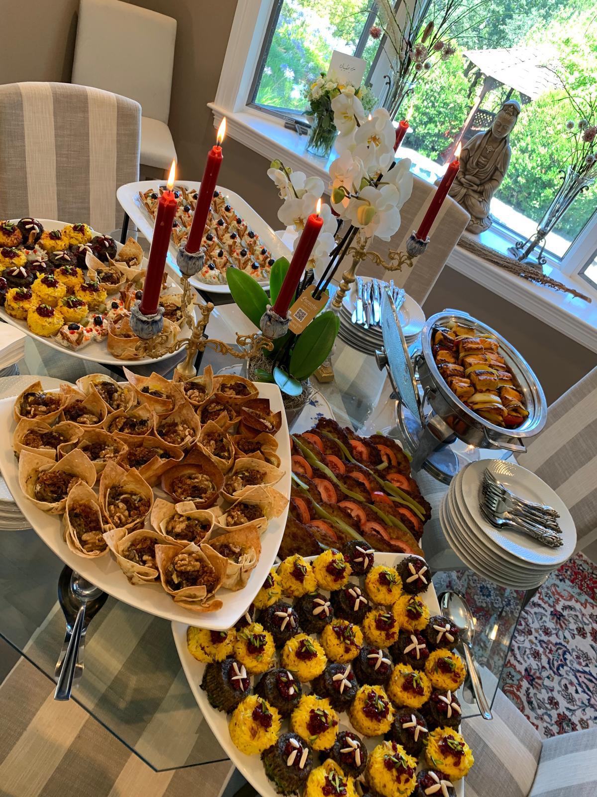Saffron Grill & Market elegant catering spread with Persian appetizers and candles