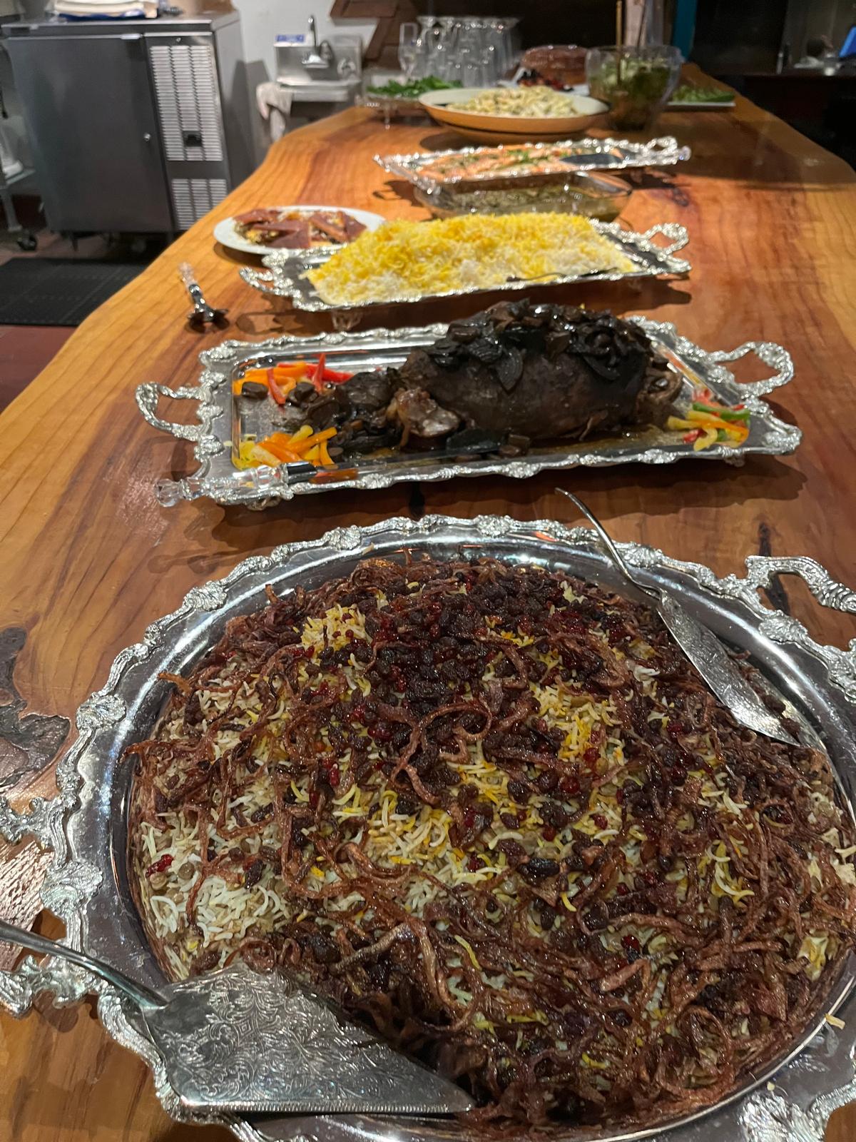 Persian rice and stew catering on silver serving trays
